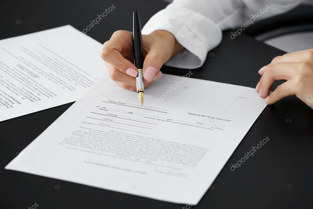 Woman signing last will and testament, closeup