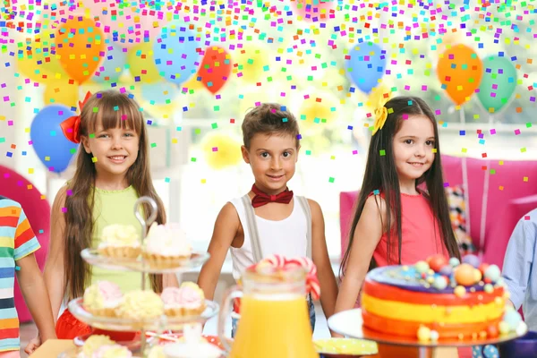 funny children at birthday party in decorated room