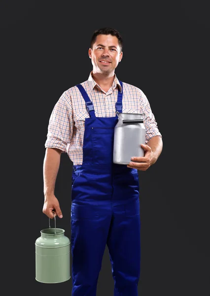 Handsome milkman on dark background — Stock Photo, Image