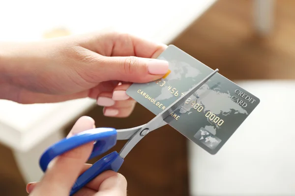 hands cutting credit card
