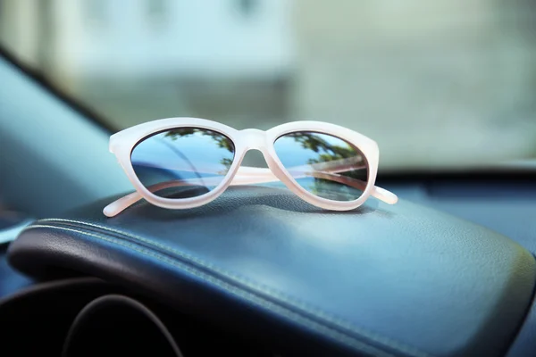 Sunglasses on car panel, closeup — Stock Photo, Image