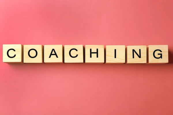 Coaching concept. Houten kubussen op roze achtergrond — Stockfoto