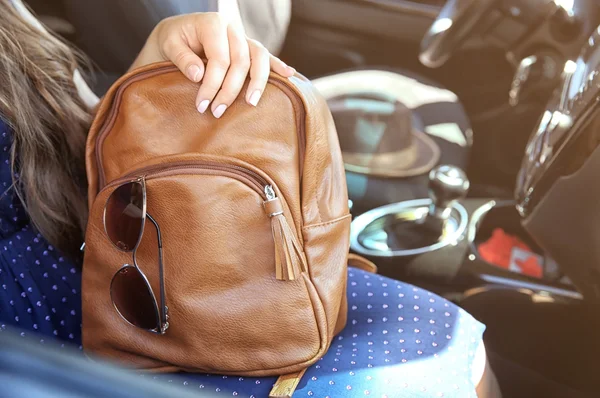 Girl with backpack and sunglasses in car — Stock Photo, Image