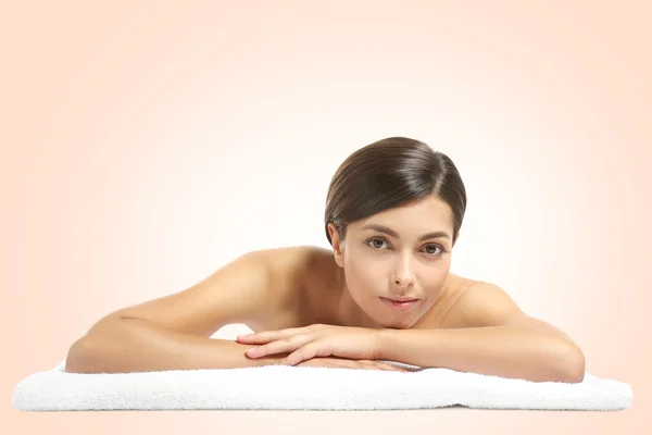 Young beautiful woman with towel on light background — Stock Photo, Image