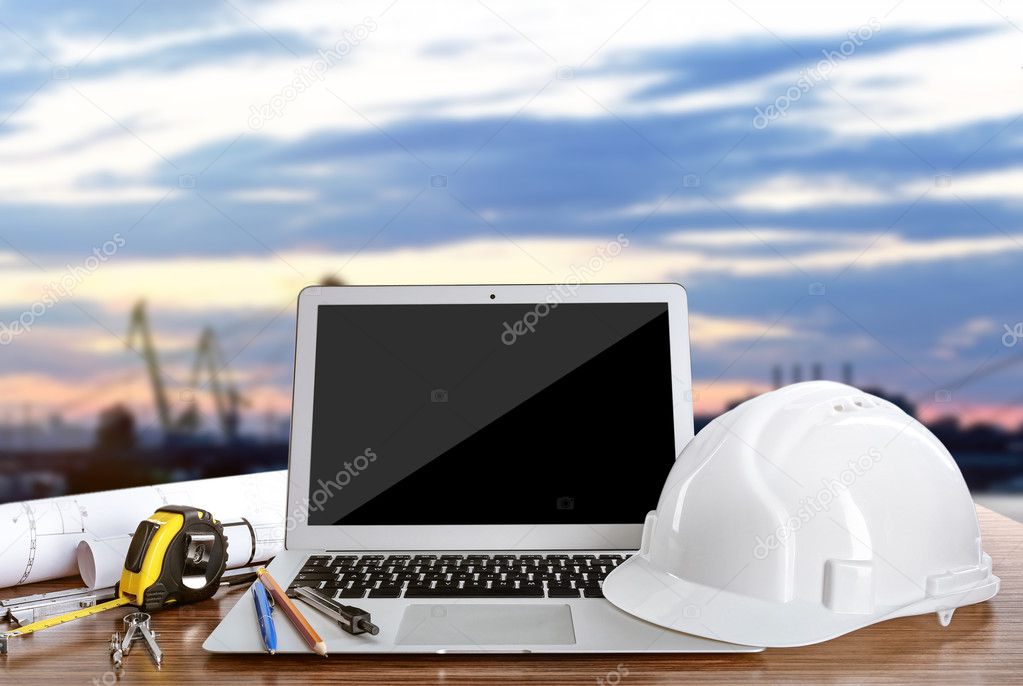 Laptop with construction tools on blue sky background