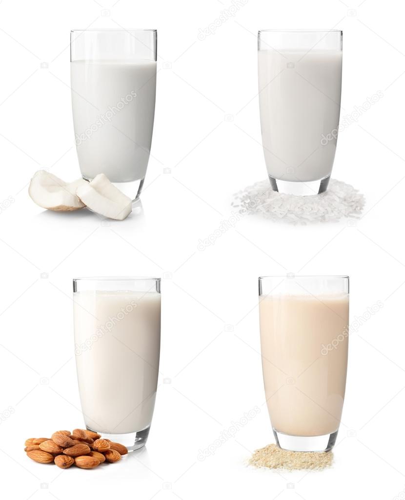 Glasses of milk with almond, sesame, coconut and rice isolated on white