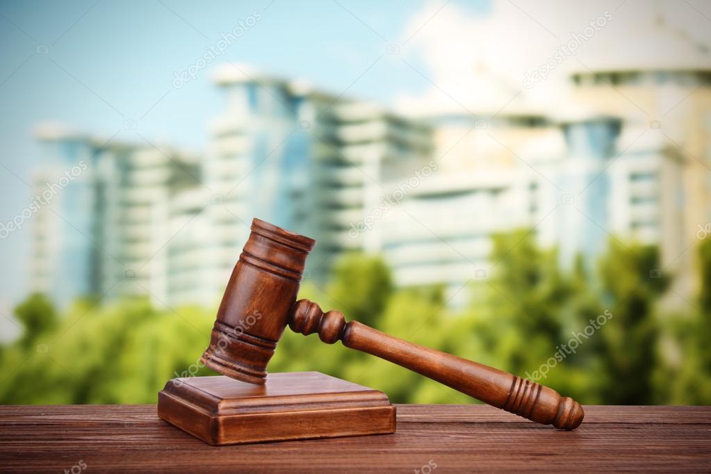 Judge's gavel and books on blurred building background