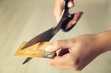 hands cutting credit card 