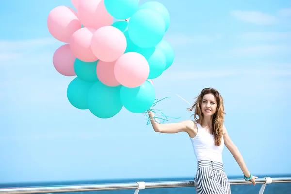 Woman with colorful balloons — Stock Photo, Image