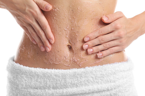 Woman applying nourishing scrub on body on white background, closeup