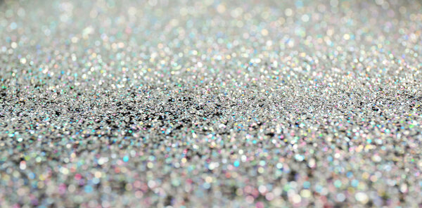 Glittering silver sparkles textured background