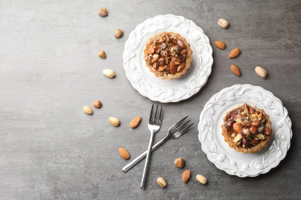 Delicious cakes with nuts on table