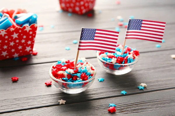 Sprinkles in glass bowls with USA flag on dark wooden background — Stock Photo, Image