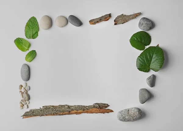 Rectangular frame made of pebbles, leaves and bark isolated on white — Stock Photo, Image