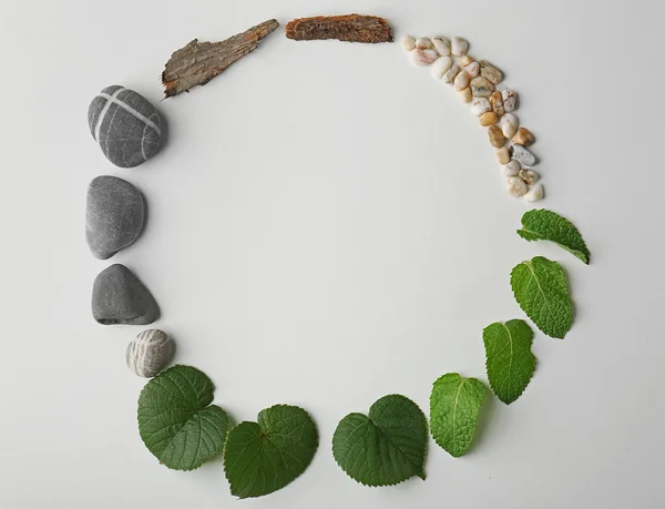 Circular frame made of pebbles, leaves and bark isolated on white — Stock Photo, Image