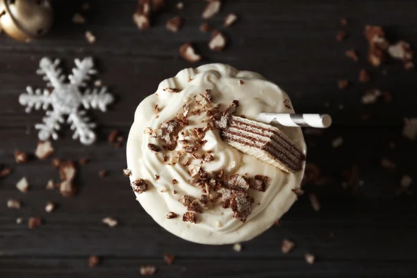 Delicious milkshake with Christmas decoration on wooden background — Stock Photo, Image