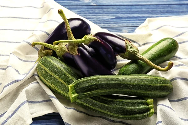 Fresh zucchini and eggplants on napkin, closeup — Stock Photo, Image