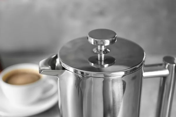 New coffee maker and cup of fresh drink on table — Stock Photo, Image