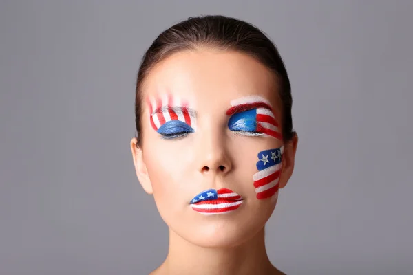 Girl with USA makeup on grey background — Stock Photo, Image