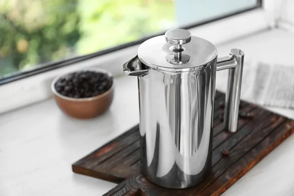 New coffee maker on cutting board on windowsill — Stock Photo, Image