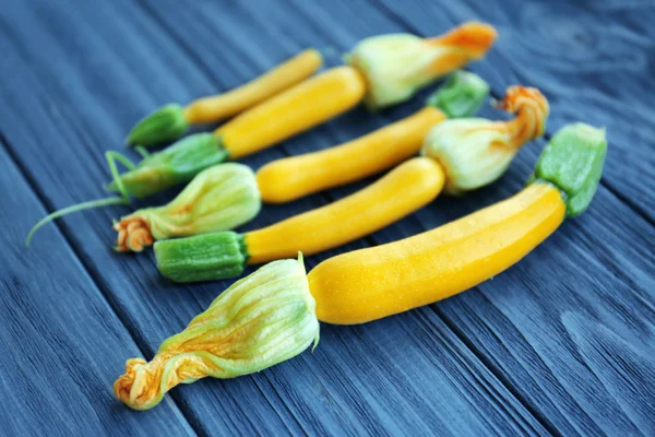 Fresh yellow zucchini on wooden background — Stock Photo, Image