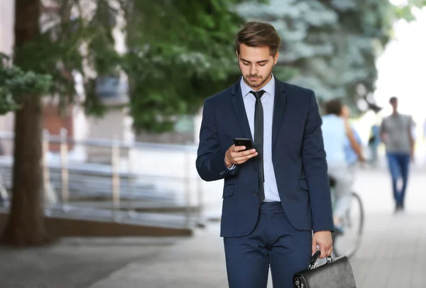 Lawyer  using smart phone on the street