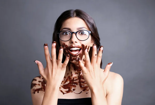 Attractive woman with smeared chocolate — Stock fotografie