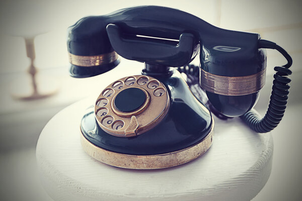 Vintage telephone on white table