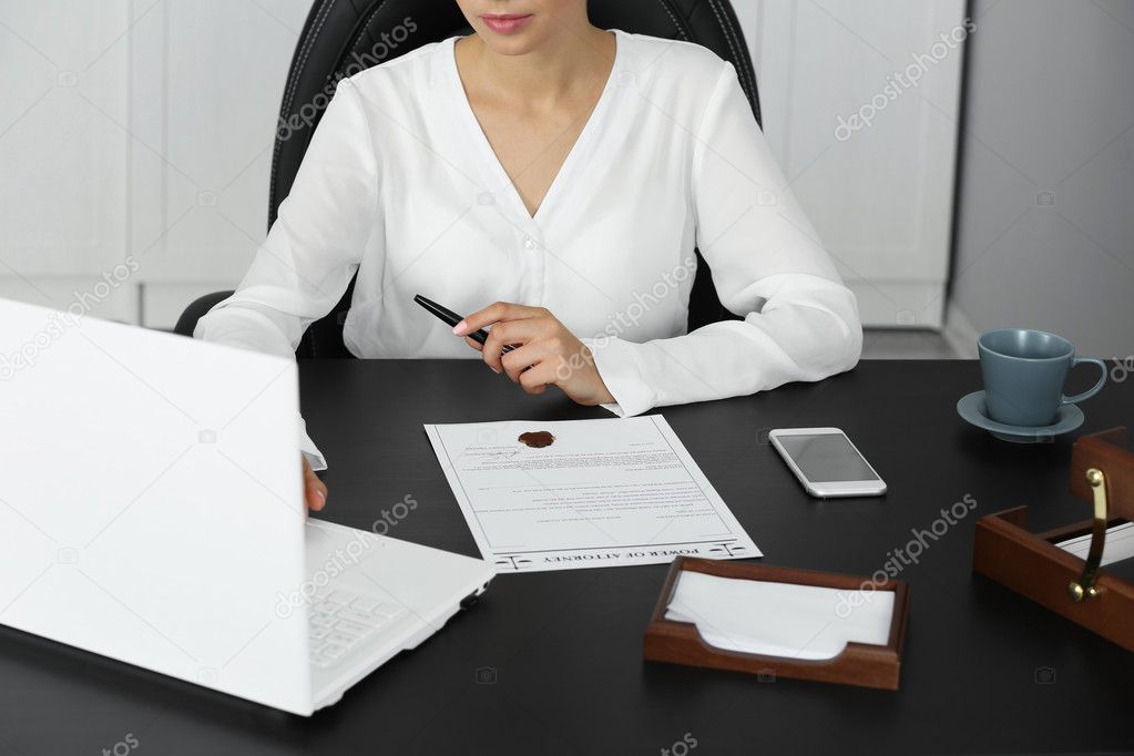 Woman working with laptop in modern office