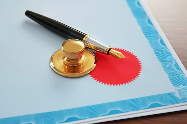 Pen, stamp and document on notary public table — Stock Photo, Image