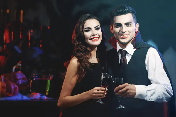 Young people dressed as vampires drinking cocktails at Halloween party — Stock Photo, Image