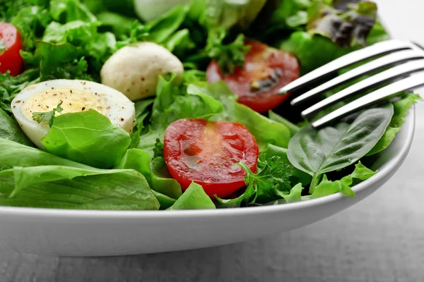 Bowl of fresh mixed salad leaves with tomatoes closeup — Stock Photo, Image