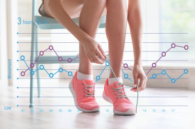 Woman tying shoelace at home. Graphic of training results. Health care and sport concept.