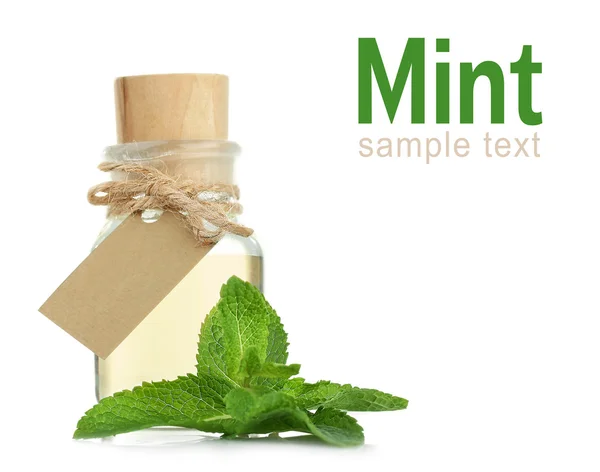 Glass bottle of essential oil, closeup. Word MINT on white background. Spa beauty concept. — Stock Photo, Image