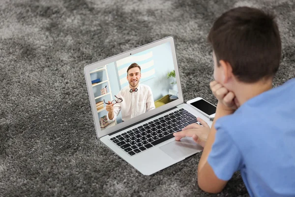 Boy video conferencing on laptop with father, Video call and chat concept.