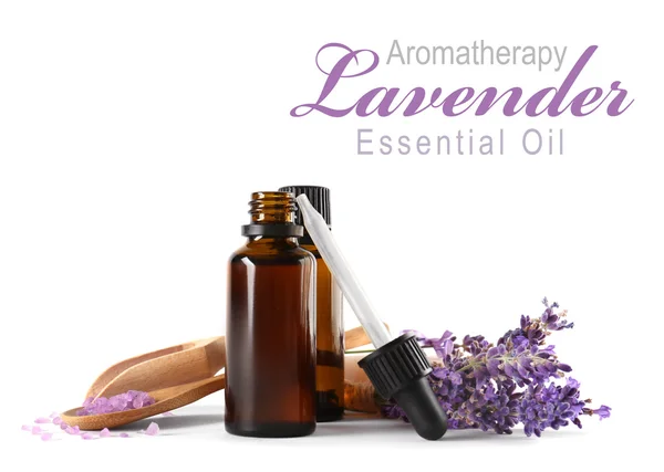 Spa composition with essence, closeup. Text AROMATHERAPY LAVENDER ESSENTIAL OIL on white background. Spa beauty concept.