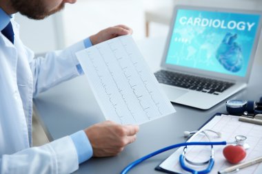Cardiologist working at office. Health care concept. clipart