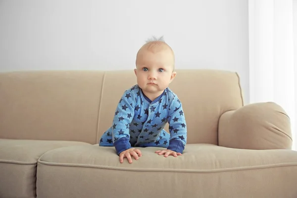 Adorable little baby crawling on sofa — Stock Photo, Image