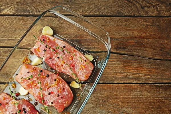 Steaks in marinade with thyme — Stock Photo, Image