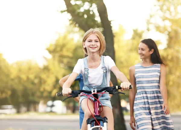 Cheerful Girl Riding Bicycle Friends Park — Stock Photo, Image