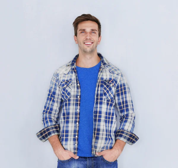 Young happy man on light background — Stock Photo, Image