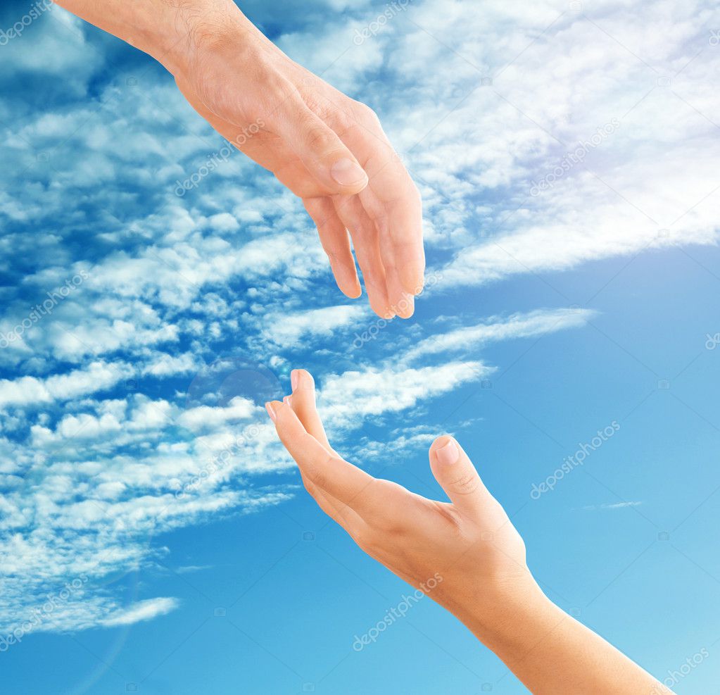 Female and male hands reaching to each other on sky background. Help and care concept.