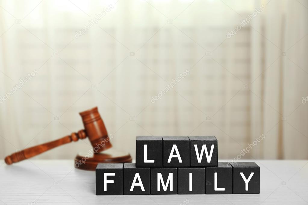 Black cubes with phrase LAW FAMILY and gavel on white table