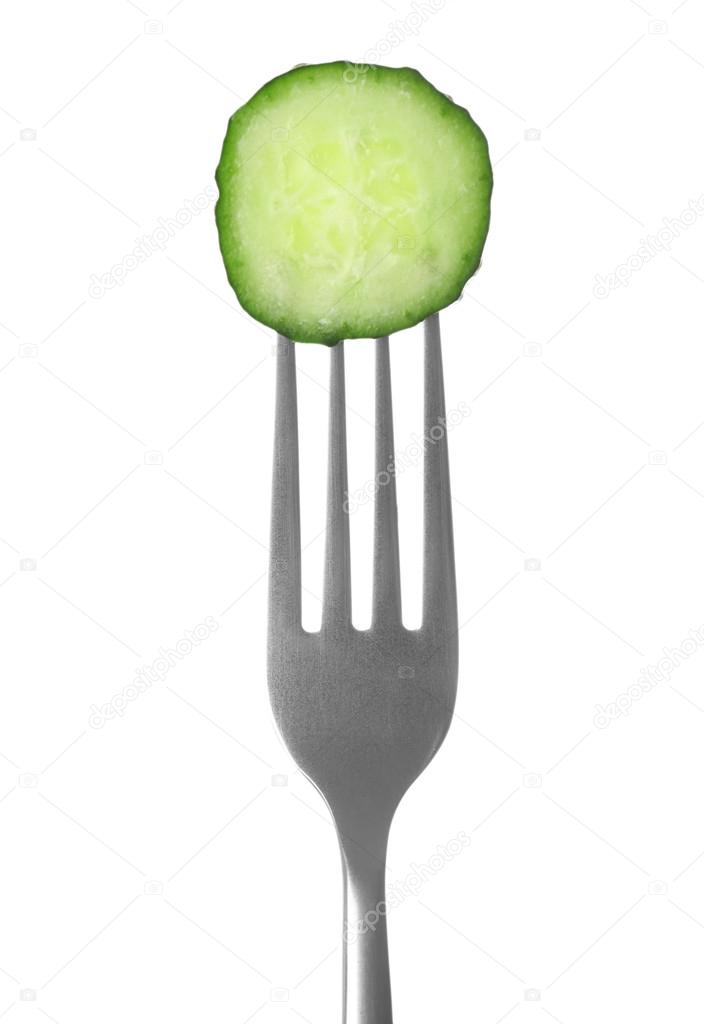 Fork with cucumber slice on white  background