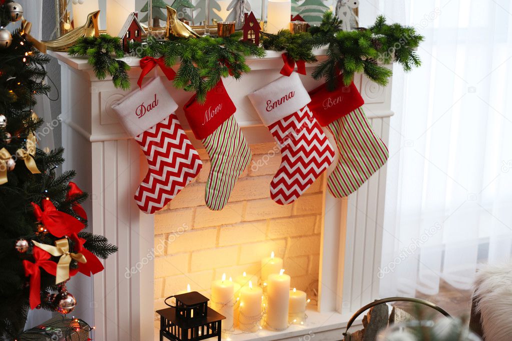 Cute Christmas stockings hanging on fireplace