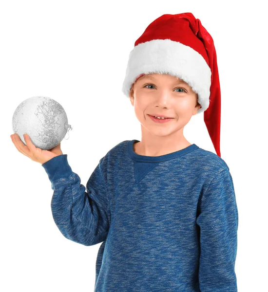 Menino bonito em chapéu de Papai Noel com bola de Natal no fundo branco — Fotografia de Stock