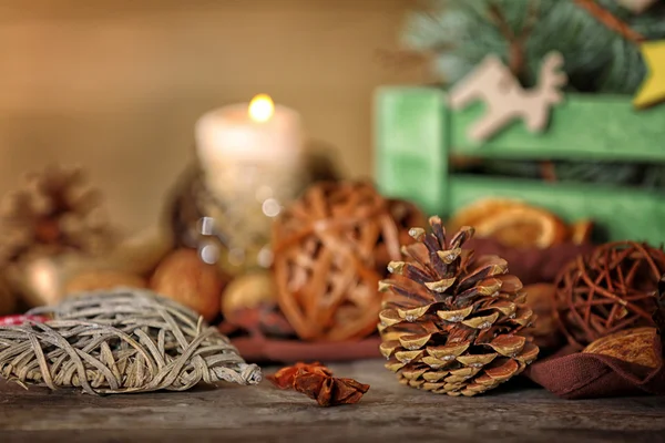 Composition of cone, anise and wicker decor on wooden background, close up view — Stock fotografie