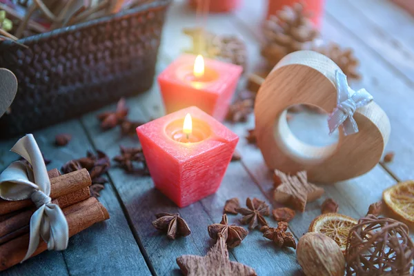 Composition of candles and natural decor on wooden background, close up view — Stock Photo, Image