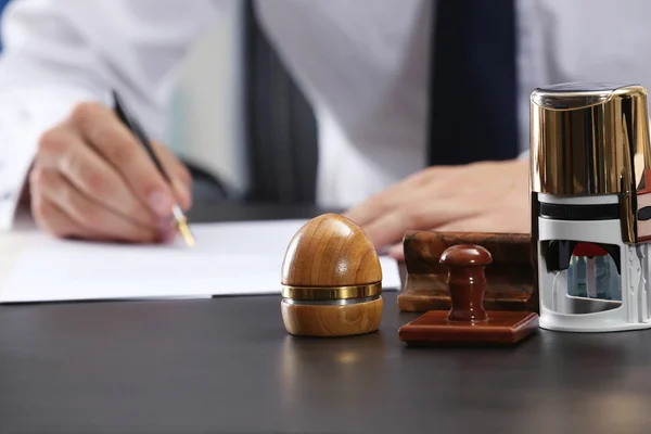 Stamps and ink pad on notary table — Stock Photo, Image