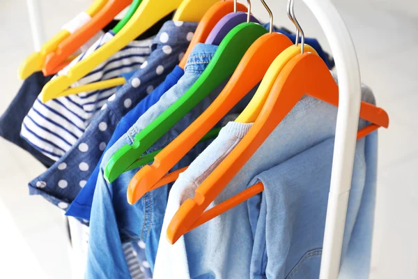 Clothes hanging on rack, closeup — Stock Photo, Image